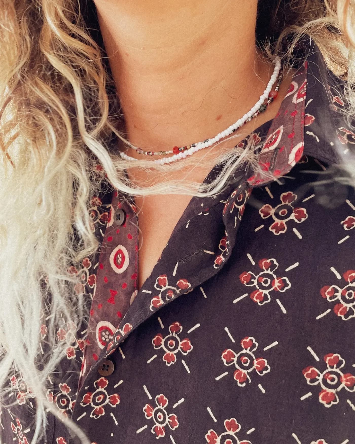 Close-up of the collar and floral motif of a dark shirt