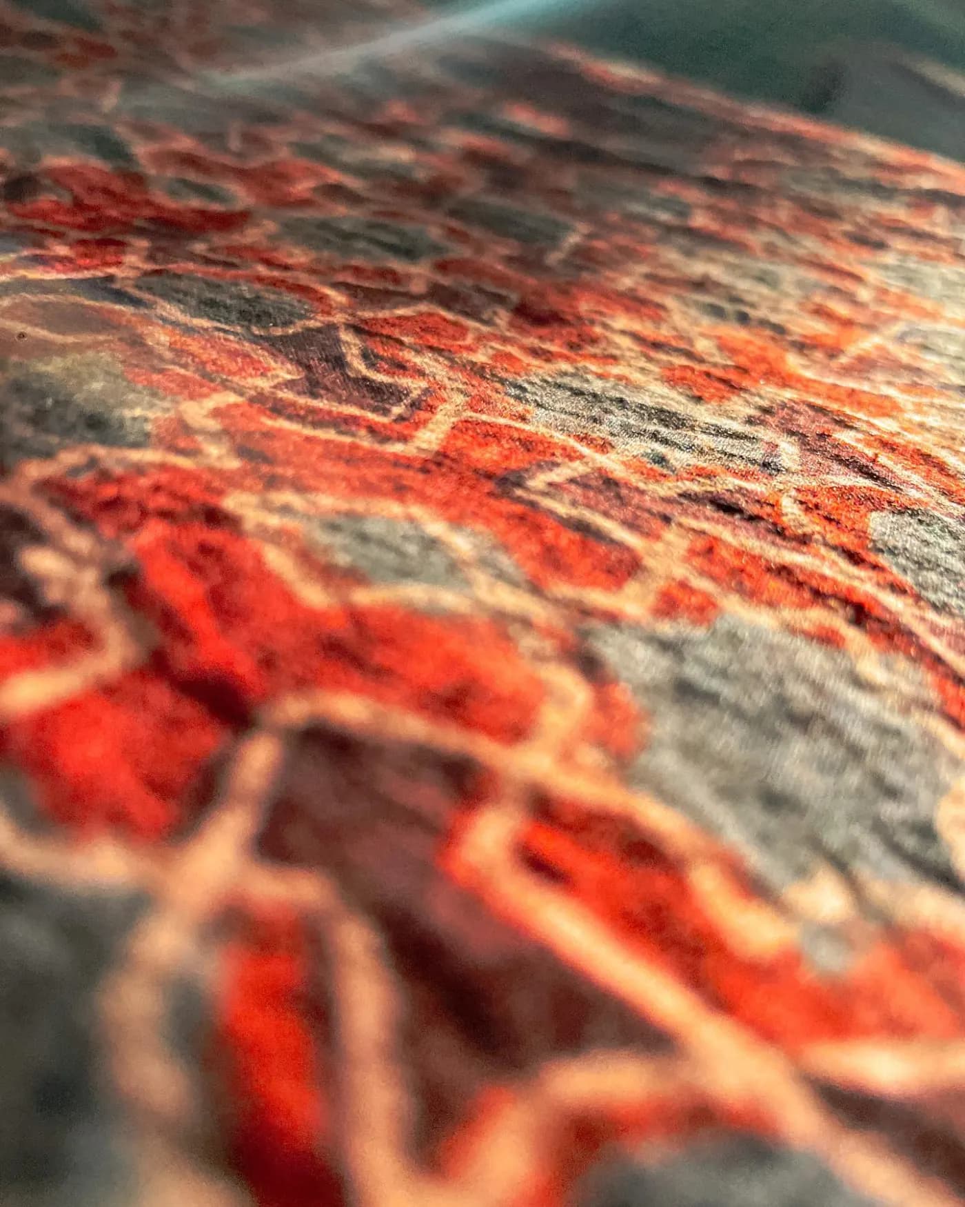 Close-up of a red, black and cream textile with geometric motifs